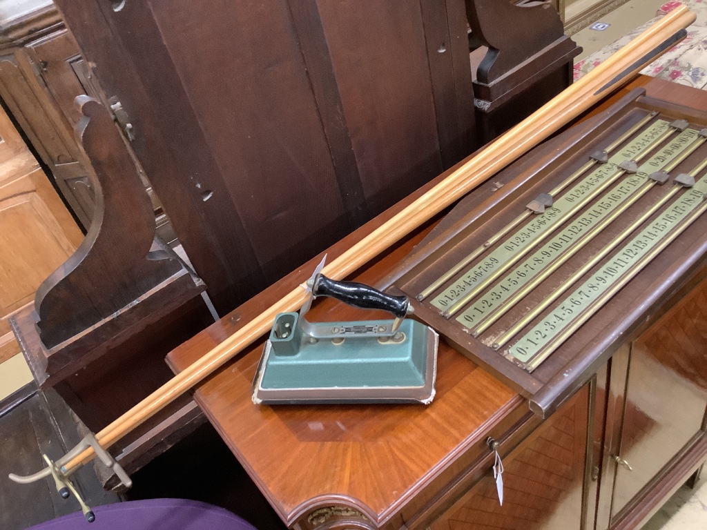 A snooker scoreboard, width 70cm, two rests, cue and a baize iron